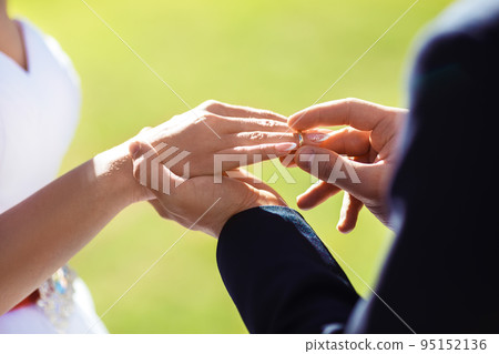 Wedding engagement rings. Married couple exchange wedding rings at a wedding ceremony. Wedding engagement rings. Married couple exchange wedding rings at a wedding ceremony. 95152136