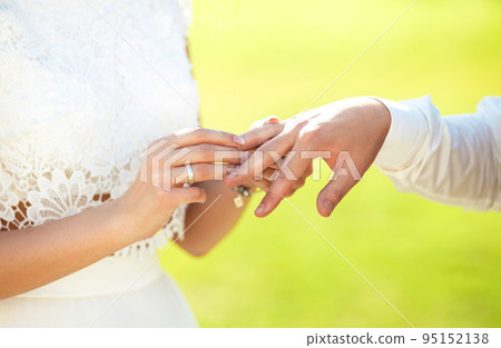 Wedding engagement rings. Married couple exchange wedding rings at a wedding ceremony. 95152138