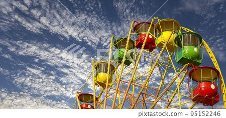 Attraction (carousel) ferris wheel on the background of the cloudy sky 95152246