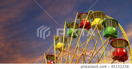 Attraction (carousel) ferris wheel against the background of a romantic evening sky 95152256