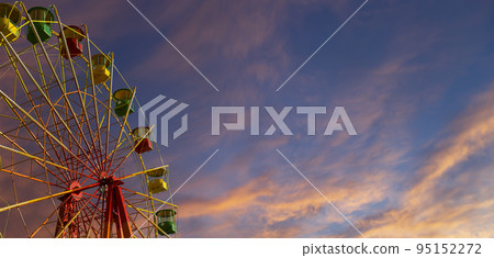 Attraction (carousel) ferris wheel against the background of a romantic evening sky 95152272