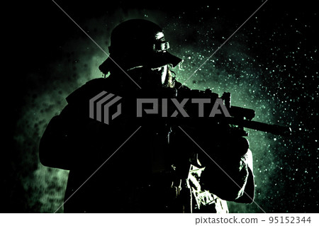 Commando fighter, professional mercenary, special forces soldier with camouflaged face, loaded with ammunition, armed assault rifle, patrolling on secret mission, sneaking in darkness ready to fight 95152344