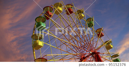 Attraction (carousel) ferris wheel against the background of a romantic evening sky Attraction (carousel) ferris wheel against the background of a romantic evening sky 95152376