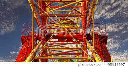 Attraction (carousel) ferris wheel against the background of a romantic evening sky Attraction (carousel) ferris wheel against the background of a romantic evening sky 95152397