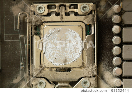 Very dirty computer processor. Dusty CPU microchip on a computer motherboard with traces of cooler grease. The electronic board in the computer workshop is prepared for cleaning. Service electronics 95152444