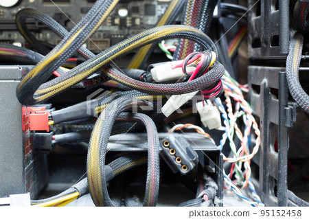 Very dirty wires, connectors and plugs in the computer. Old multi-colored wires in a braided wrapper. Stranded electrical wire in electronic equipment. Service workshop for electronics repair. Very dirty wires, connectors and plugs in the computer. Old multi-colored wires in a braided wrapper. Stranded electrical wire in electronic equipment. Service workshop for electronics repair. 95152458