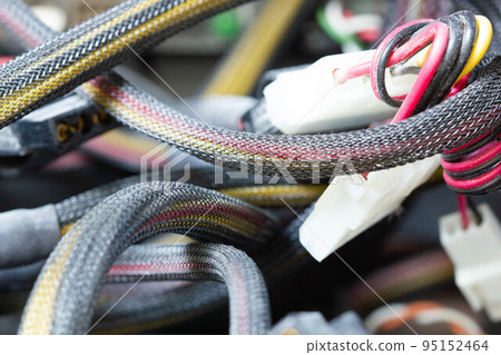 Very dirty wires, connectors and plugs in the computer. Old multi-colored wires in a braided wrapper. Stranded electrical wire in electronic equipment. Service workshop for electronics repair. Very dirty wires, connectors and plugs in the computer. Old multi-colored wires in a braided wrapper. Stranded electrical wire in electronic equipment. Service workshop for electronics repair. 95152464