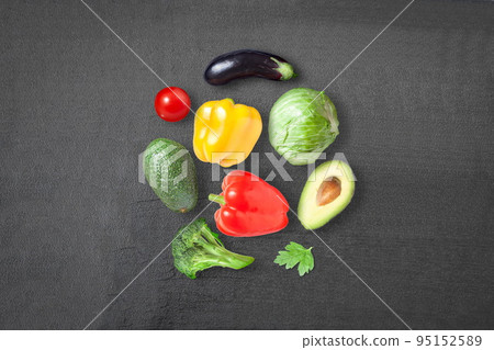 Ripe vegetables on a dark background - eggplant, sweet pepper, cabbage, avocado, tomato and sweet pepper 95152589