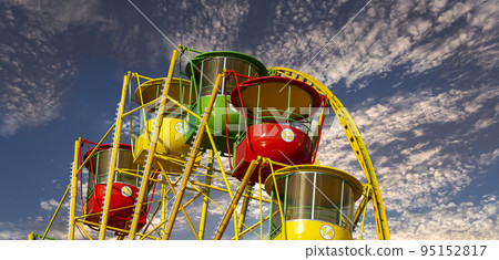 Attraction (carousel) ferris wheel against the background of a romantic evening sky 95152817