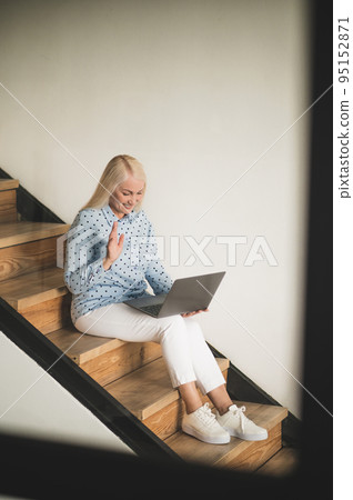 Joyous woman communicating with someone via Skype 95152871