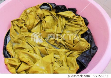 Rain jacket and pants sorked in a basin, Tokyo, Japan, August 2, 2022 95153185