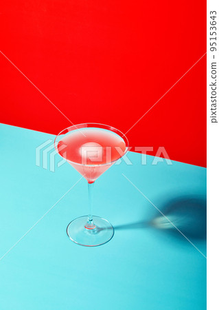 Multi-colored cocktails in glasses of different shapes on colored backgrounds with hard shadows 95153643
