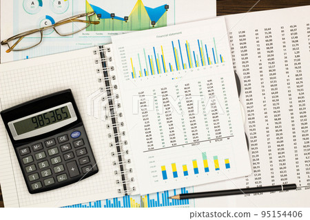 Top view office table desk. Financial report. Flat lay. Workspace with Business office supplies, Accounts number on the data paper, diagrams, pencil, glasses, calculator. Copy space for text. Top view Top view office table desk. Financial report. Flat lay. Workspace with Business office supplies, Accounts number on the data paper, diagrams, pencil, glasses, calculator. Copy space for text. Top view 95154406