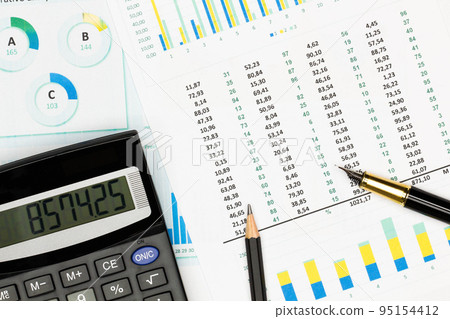 Top view office table desk. Financial report. Flat lay. Workspace with Business office supplies, Accounts number on the data paper, pencil, pen, glasses, calculator on the table. Top view. Close-up Top view office table desk. Financial report. Flat lay. Workspace with Business office supplies, Accounts number on the data paper, pencil, pen, glasses, calculator on the table. Top view. Close-up 95154412