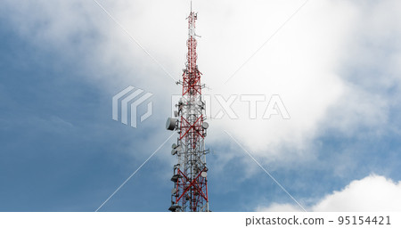 Large transmission tower against deep blue sky and clouds 95154421