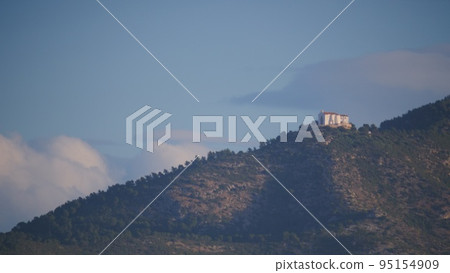 Spanish coast landscape with church on hill 95154909