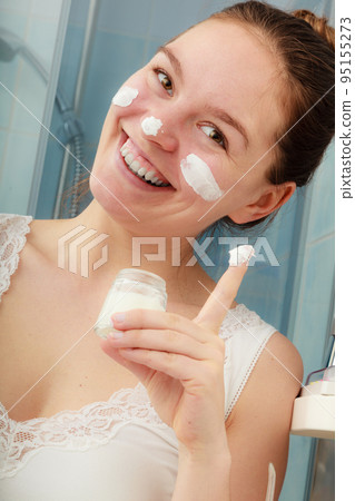 Woman with moisturizing skin cream. Skincare. 95155273