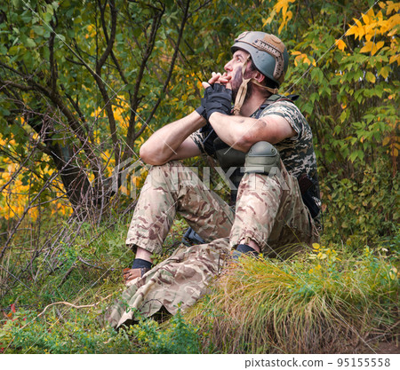 Sad soldier sits on the ground Sad soldier sits on the ground 95155558