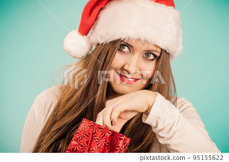 Christmas woman puts her hand into gift bag 95155622