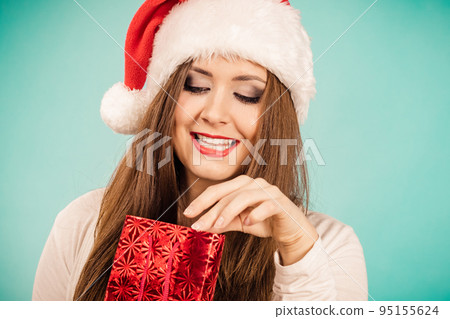 Christmas woman puts her hand into gift bag 95155624