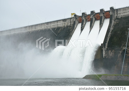 water splashing from floodgate Khun Dan Prakarn Chon huge concrete dam in Thailand  95155716