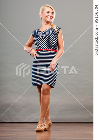 Mid adult woman in summer striped dress 95156504