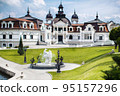Great large house with green lawns on a lake 95157296