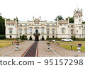 Exterior of a beautiful old house with white retro car 95157298
