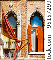 Colored ancient wall with windows and shutters 95157299