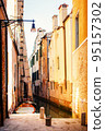 Boat moored between colorful houses 95157302