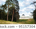Beautiful mansion on a hill. Around the trees and green grass 95157304