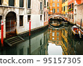 Boat moored between colorful houses. Canals in Venice, Italy 95157305