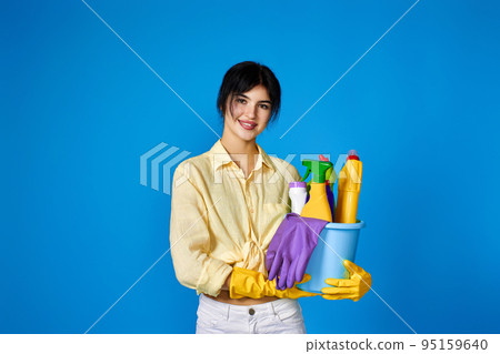 woman in gloves holding bucket with cleaning supplies woman in gloves holding bucket with cleaning supplies 95159640