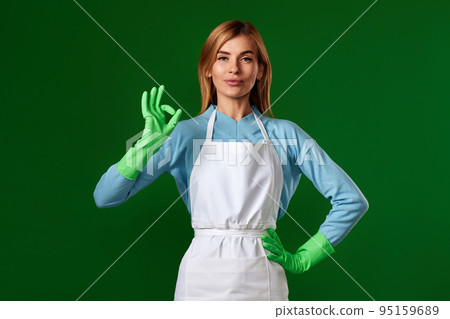 smiling blonde woman in rubber gloves showing ok smiling blonde woman in rubber gloves showing ok 95159689