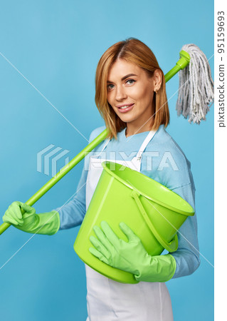 woman in rubber gloves holding mop and bucket 95159693