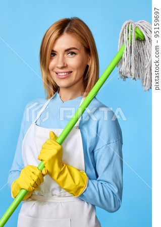 woman in rubber gloves holding mop and bucket woman in rubber gloves holding mop and bucket 95159697