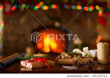 New Year or Christmas Gift Box with Red Ribbon. Fireplace background 95159712