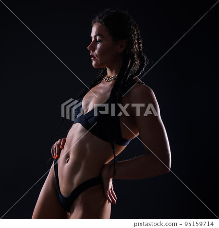 Close-up shot of young woman waist with muscular abdominal muscles. Abs of fit female athlete. Close-up shot of young woman waist with muscular abdominal muscles. Abs of fit female athlete. 95159714
