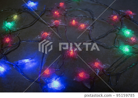 Christmas garlands with glowing light bulbs Christmas garlands with glowing light bulbs 95159785