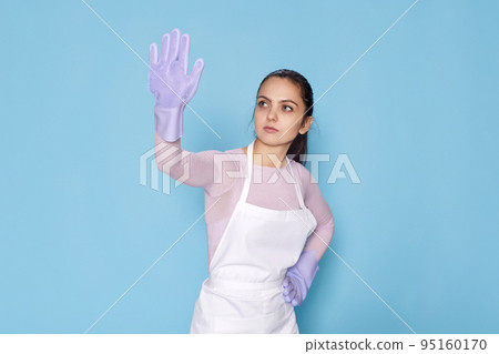 woman in purple rubber gloves and cleaner apron cleaning 95160170
