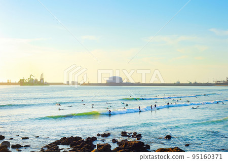 Surfers Matosinhos Leixoes Port sunset 95160371