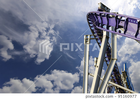 Attraction roller-coaster (switchback) on the background of the cloudy sky 95160977
