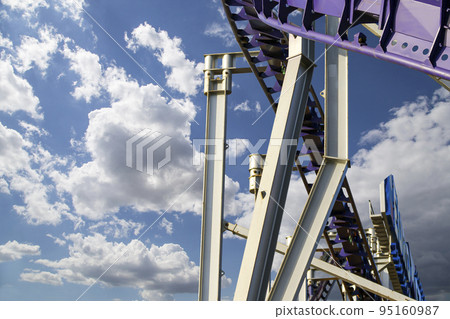 Attraction roller-coaster (switchback) on the background of the cloudy sky Attraction roller-coaster (switchback) on the background of the cloudy sky 95160987