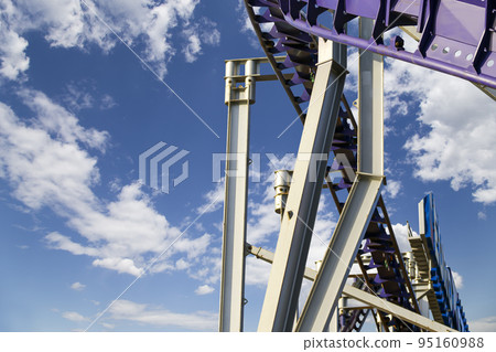 Attraction roller-coaster (switchback) on the background of the cloudy sky Attraction roller-coaster (switchback) on the background of the cloudy sky 95160988