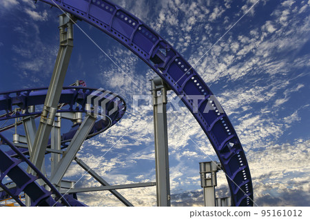 Attraction roller-coaster (switchback) on the background of the cloudy sky 95161012