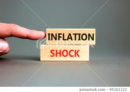 Inflation shock symbol. Concept words Inflation shock on wooden blocks. Beautiful grey table grey background. Businessman hand. Business inflation shock concept. Copy space. 95161122