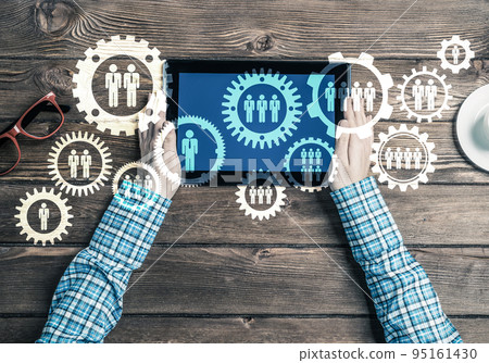 Concept of teamworking and connection with gears mechanism and tablet pc 95161430