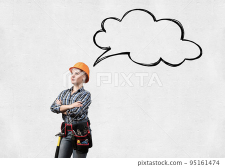 Confident female worker in safety helmet Confident female worker in safety helmet 95161474