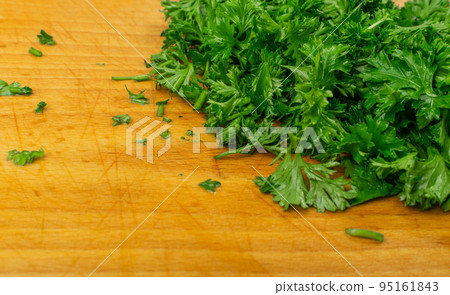 Fresh Green Chopped Parsleyon Wooden Cutting Board Background Fresh Green Chopped Parsleyon Wooden Cutting Board Background 95161843