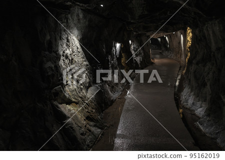 Dark tunnel of abandoned underground marble quarry Dark tunnel of abandoned underground marble quarry 95162019